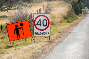 Roadwork sign with 40 km h speed limit on a roadside in Australia.