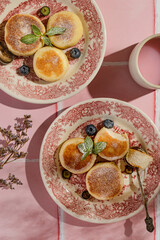 cheesecakes with powdered sugar on a pink background