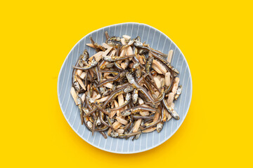 Almonds Mixed Anchovy in plate on yellow background.