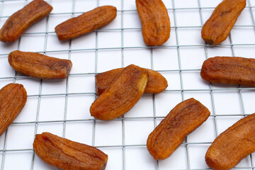 Sun dried bananas on white background.