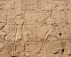 Ancient Egyptian murals and writings on the stone walls of the Karnak Temple in Luxor