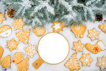 Pattern of gingerbread cookies in different shapes on a snow surface. Top view.