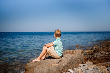 child european sitting on the beach by the sea