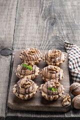 Shortcrust pastry with whipped cream custard and walnut on wooden table