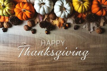 Happy Thanksgiving Day with pumpkin and nut on wooden table