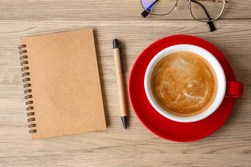 blank notebook and coffee cup on wood table. Motivation, Resolution, To do list, Strategy and Plan concept