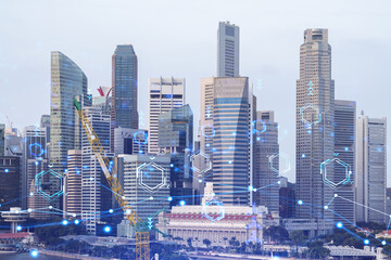 Obraz premium Technology hologram over panorama city view of Singapore. The largest tech hub in Asia. The concept of developing coding and high-tech science. Double exposure.