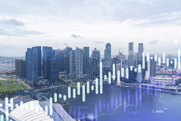 Financial stock chart hologram over panorama city view of Singapore, business center in Asia. The...