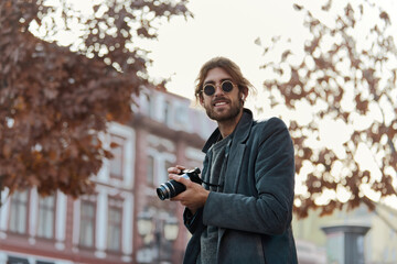 Tourist photographer with camera in autumn town