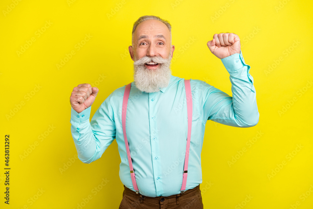 Sticker Photo of hooray beard aged man hands fists wear blue shirt isolated on vivid yellow color background