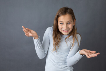 Portrait of a young happy girl on grey background with space for text - 463813618