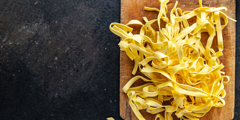 raw pasta home cooking tagliatelle handmade durum wheat fresh meal snack on the table copy space food background rustic 