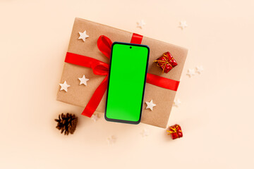 Chrismas flat lay with holiday decorations and phone with green screen. Chroma key.