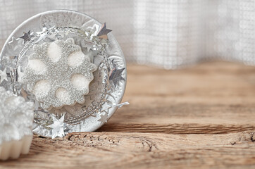christmas candles in the shape of snowflakes on a wooden background