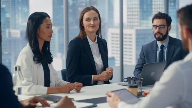 Modern Multi-Ethnic Office Conference Room Meeting: Ambitious Beautiful Caucasian Businesswoman Presenting Investment Strategy to Partners, Pitching Investment Strategy. Diverse Team Businesspeople