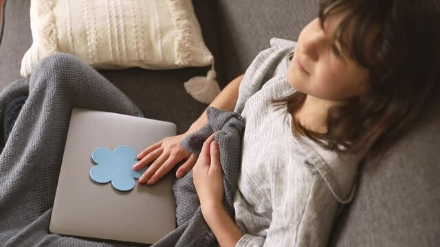 indoor portrait of pre-teen girl doing homework online or browsing internet, mdeia technologies, digital communication or shopping, teenager lifestyle. 