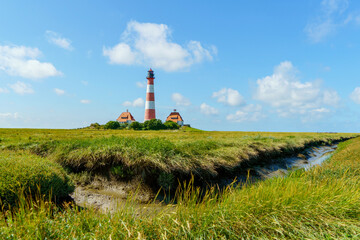 Fototapeta na wymiar Lighthouse Westerhever in Schleswig Holstein, Germany. View on landscape by national park Wattermeer in Nordfriesland.