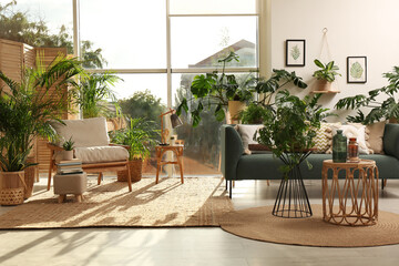 Stylish room interior with different houseplants and furniture near window