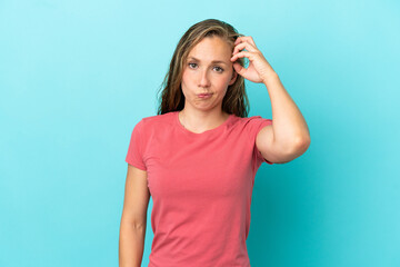 Young caucasian woman isolated on blue background with an expression of frustration and not understanding