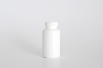 Pills bottle. White medical container for drugs, diet, nutritional supplements. White plastic jar for pills. Packaging mockup template. Free space, copy space.