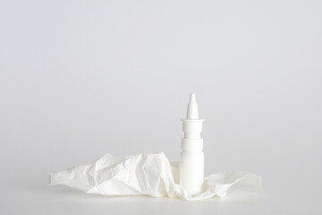 White plastic nasal spray bottle on white background. Nasal spray container, saline water solution...
