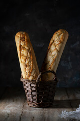 Fresh baguettes with garlic in a wicker basket