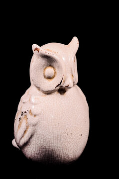 Vertical Shot Of A White Owl Statue Isolated On A Black Background