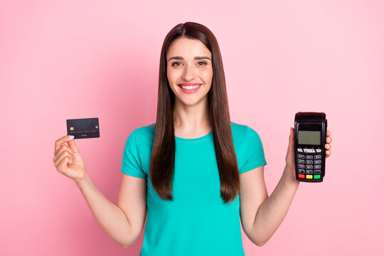 Photo of young woman happy positive smile hold hands bank card terminal pay pass pay isolated over pink color background
