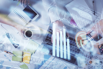 Double exposure of man's hands typing over computer keyboard and tech theme hologram drawing. Top view. Technology concept.