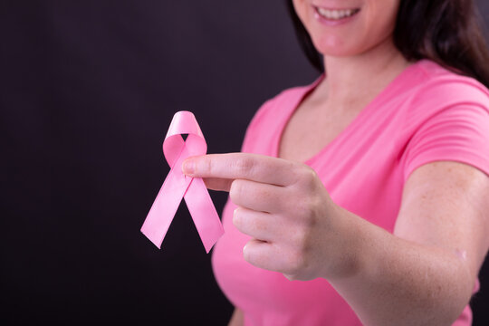 Midsection Of Happy Caucasian Woman In Pink Tshirt Holding Pink Ribbon