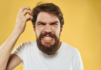 Obraz premium national bearded man in white t-shirt discontent yellow background
