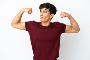 Young Argentinian man isolated on white background doing strong gesture