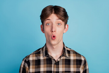Obraz na płótnie Canvas Photo of young man amazed shocked surprised fake novelty news reaction isolated over blue color background