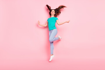 Full size photo of young attractive woman happy positive smile fly air hair jump up isolated over pastel color background