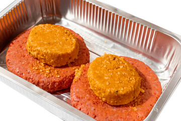 Two big size fresh beef burgers with smoky barbeque cheese melt on top in a foil tray on white background. Meat industry product for cooking home. Premium top quality hamburger.