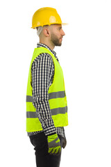 Side view of construction worker in reflective clothes and hardhat. Waist up. Isolated.