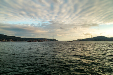 fisherman fishing boats on Bosporus Istanbul on a Foggy sunrise. Rainy clouds and dark weather