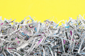 The shredded paper on light yellow background.
