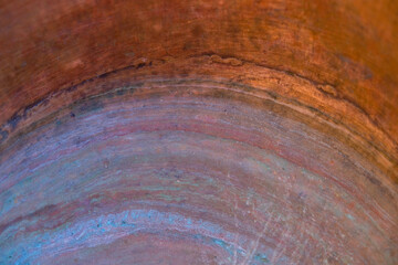Copper background. Daylight. Colored oxidized circles. Decorative effect.