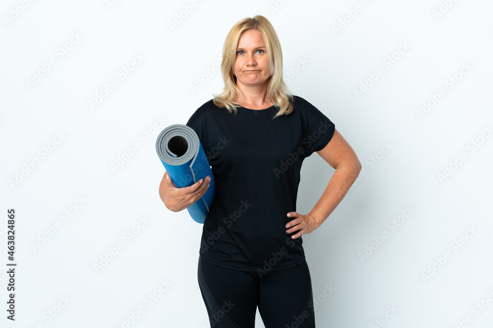 Canvas Prints Middle age woman going to yoga classes while holding a mat isolated on white background with sad expression