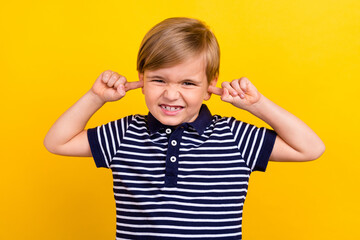 Photo portrait little boy wearing casual clothes closed ears with fingers isolated bright yellow color background