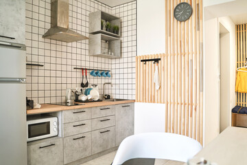 Modern kitchen landscape. Home interior. Light counter. No people. Lifestyle design. Fridge and cooking panel