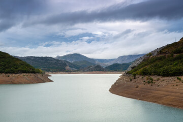 Obraz premium Landscape of Barrios de Luna Reservoir, mountains and cloudy sky. Province of León, Spain.