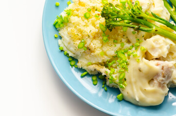 Tender pieces of smoked haddock and pollock in a creamy cheese sauce sat beneath buttery mash served with green vegetables