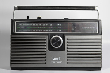 1970s-1980s portable AMFM portable stereo with 8 track cassette player. Flat white background
