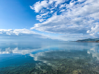 Fototapeta na wymiar clouds reflection on the lake surface, natural colors, blue background