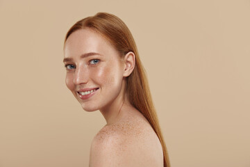 Redhead caucasian girl with naked shoulders smiles