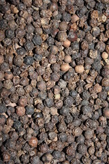 Closeup background dried black peppercorns