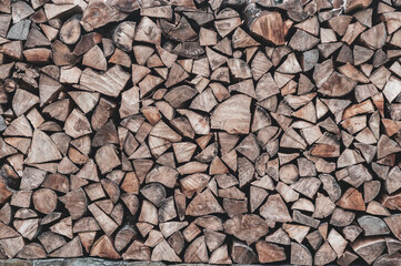 Woodpile with firewood close up. Wooden texture.