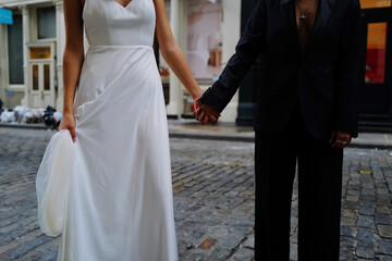Fototapeta na wymiar Lesbian couple at the wedding holding hands